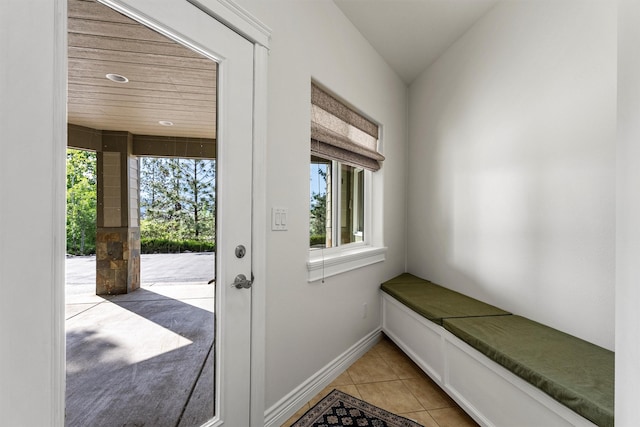 5959 Hayes Creek Rd, Missoula, MT 59804 - doorway to outside featuring healthy amount of natural light, light tile patterned flooring, and baseboards