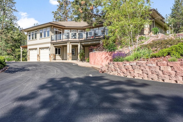 5959 Hayes Creek Rd, Missoula, MT 59804 - view of front of home featuring a balcony, an attached garage, and asphalt driveway