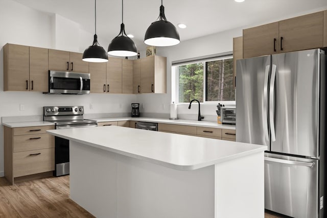 100 Bench Run, Columbia Falls, MT 59912 - kitchen featuring stainless steel appliances, light countertops, light wood finished floors, a kitchen island, and recessed lighting