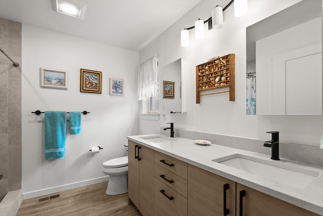 100 Bench Run, Columbia Falls, MT 59912 - bathroom with double vanity, tiled shower, and wood finished floors