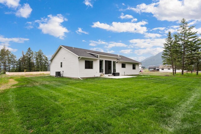 100 Bench Run, Columbia Falls, MT 59912 - rear view of house with a patio, a lawn, and cooling unit