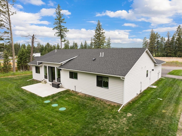 100 Bench Run, Columbia Falls, MT 59912 - rear view of property featuring a patio area, a yard, and roof with shingles