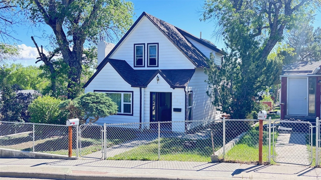 324 7th Ave, Shelby, MT 59474 - bungalow-style house featuring a gate, a chimney, a fenced front yard, and a shingled roof