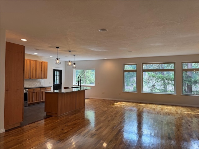 638 Trestle Creek Dr, Saint Regis, MT 59866 - kitchen with brown cabinets, open floor plan, a sink, dark wood-type flooring, and recessed lighting