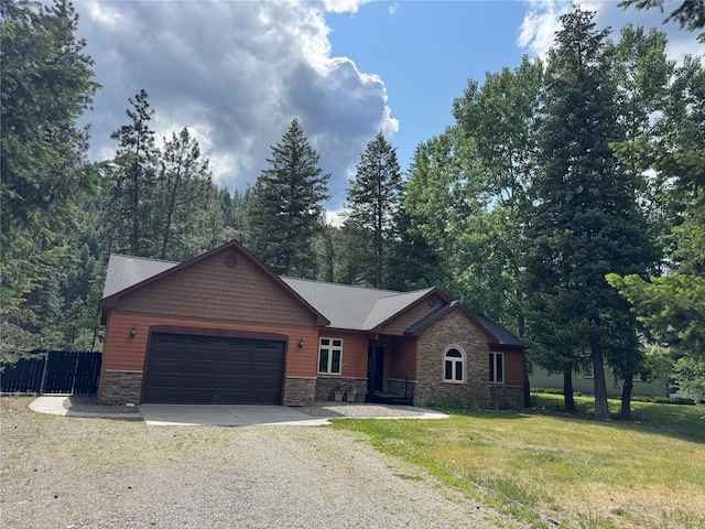 638 Trestle Creek Dr, Saint Regis, MT 59866 - view of front facade featuring stone siding, driveway, and an attached garage
