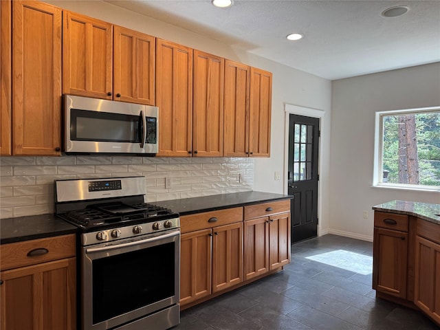 638 Trestle Creek Dr, Saint Regis, MT 59866 - kitchen featuring appliances with stainless steel finishes, decorative backsplash, baseboards, brown cabinets, and recessed lighting