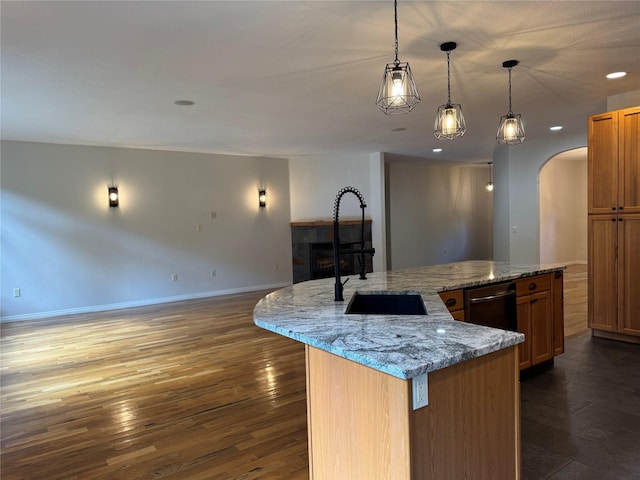 638 Trestle Creek Dr, Saint Regis, MT 59866 - kitchen featuring arched walkways, dark wood finished floors, a sink, a spacious island, and recessed lighting