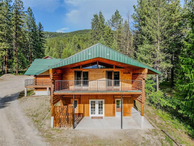 104 Swede Gulch Rd, Libby, MT 59923 - log cabin featuring french doors, a view of trees, log siding, and a patio area
