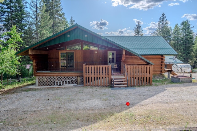 104 Swede Gulch Rd, Libby, MT 59923 - log-style house featuring covered porch, log siding, and metal roof