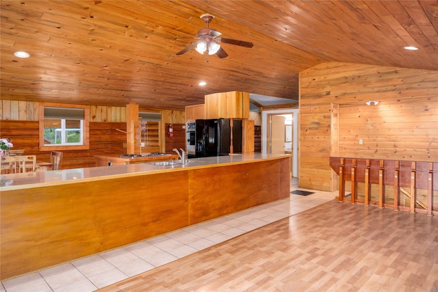 104 Swede Gulch Rd, Libby, MT 59923 - kitchen with vaulted ceiling, black fridge with ice dispenser, wooden ceiling, a sink, and ceiling fan