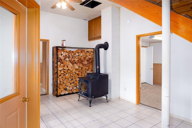 104 Swede Gulch Rd, Libby, MT 59923 - living area with a ceiling fan, a wood stove, and light tile patterned flooring