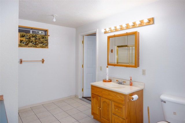 104 Swede Gulch Rd, Libby, MT 59923 - bathroom with vanity, toilet, and tile patterned floors