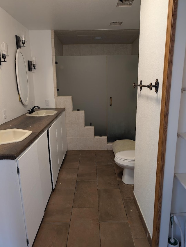 11 City Shop Rd, Shelby, MT 59474 - bathroom with toilet, double vanity, and tile patterned flooring