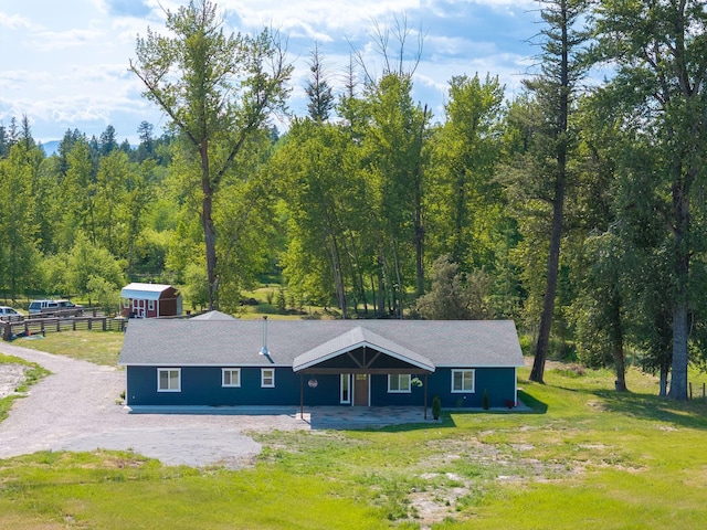 871 Conrad Dr, Kalispell, MT 59901 - single story home with a wooded view and an outdoor structure
