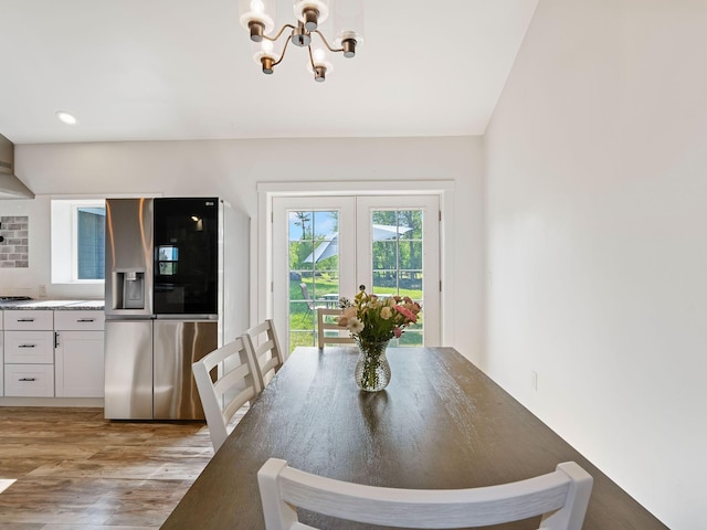 871 Conrad Dr, Kalispell, MT 59901 - dining space with light wood-style flooring, a chandelier, and french doors