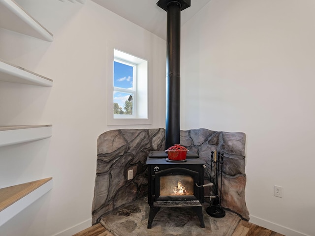 871 Conrad Dr, Kalispell, MT 59901 - detailed view of a wood stove, wood finished floors, and baseboards
