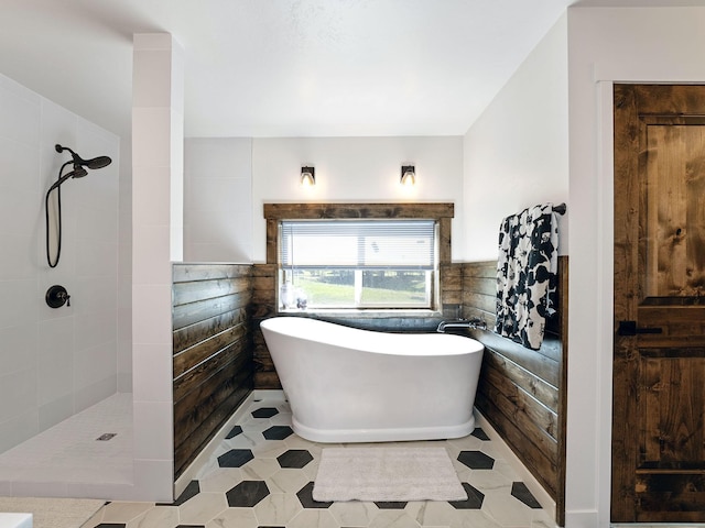 871 Conrad Dr, Kalispell, MT 59901 - full bathroom with a soaking tub, tiled shower, tile patterned floors, and tile walls