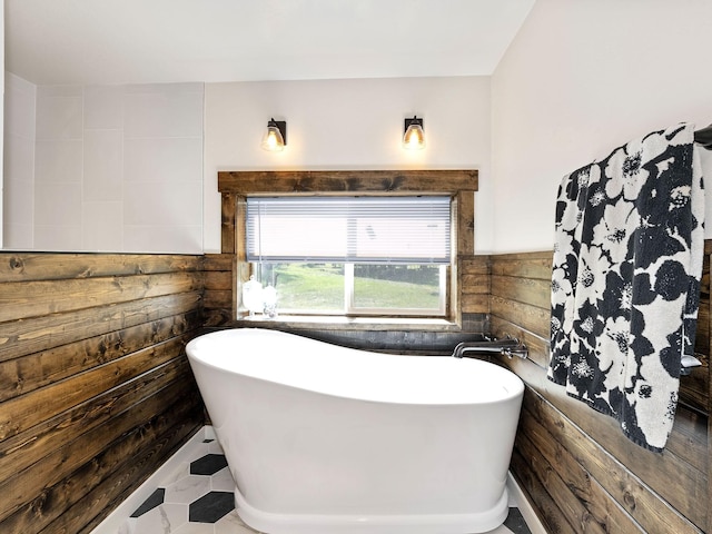 871 Conrad Dr, Kalispell, MT 59901 - full bathroom with a soaking tub, wood walls, and a wainscoted wall
