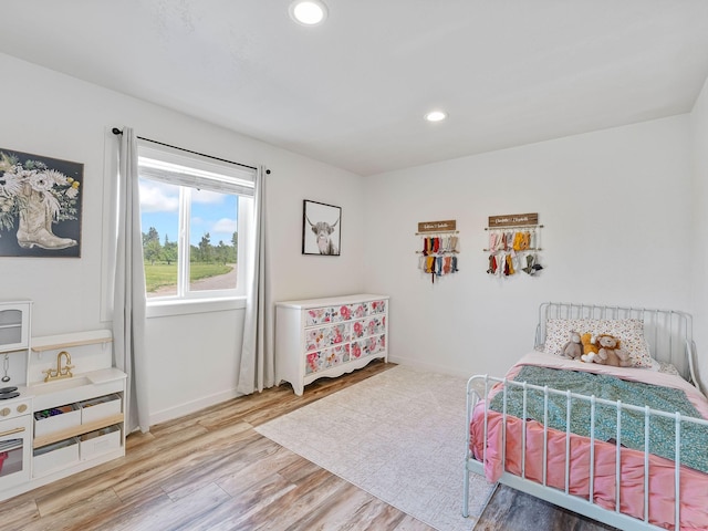 871 Conrad Dr, Kalispell, MT 59901 - bedroom with wood finished floors, recessed lighting, and baseboards