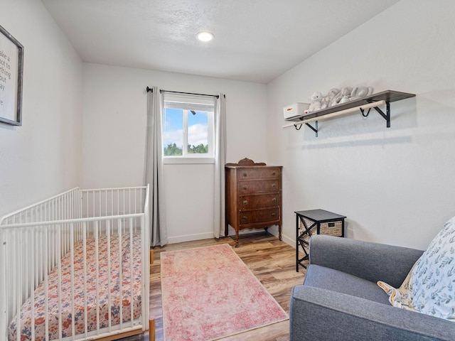 871 Conrad Dr, Kalispell, MT 59901 - bedroom with wood finished floors, baseboards, and recessed lighting