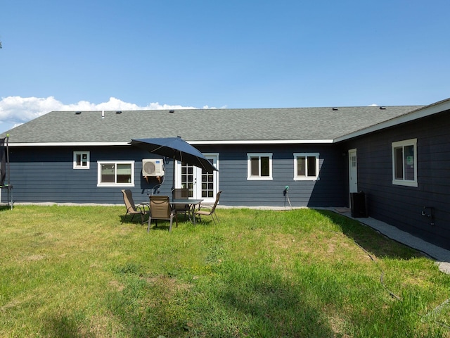 871 Conrad Dr, Kalispell, MT 59901 - back of property with a lawn and roof with shingles