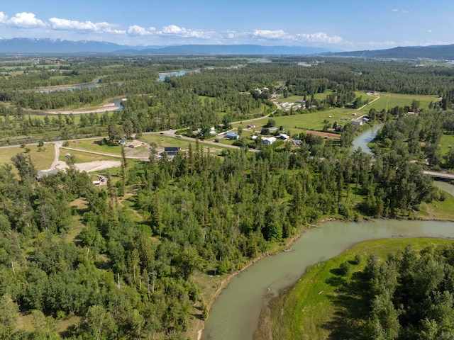 871 Conrad Dr, Kalispell, MT 59901 - aerial view of property and surrounding area with a forest and a mountain backdrop