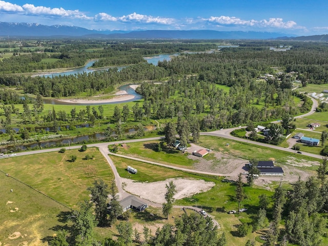 871 Conrad Dr, Kalispell, MT 59901 - aerial overview of property's location with a forest and a water and mountain view