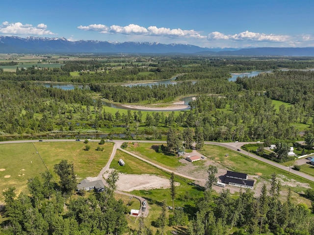 871 Conrad Dr, Kalispell, MT 59901 - aerial view of property and surrounding area with a water and mountain view and a heavily wooded area