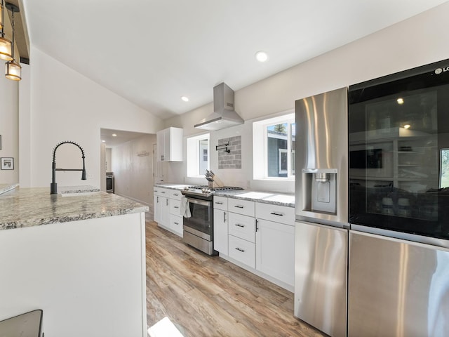 871 Conrad Dr, Kalispell, MT 59901 - kitchen featuring appliances with stainless steel finishes, island range hood, a sink, lofted ceiling, and white cabinets