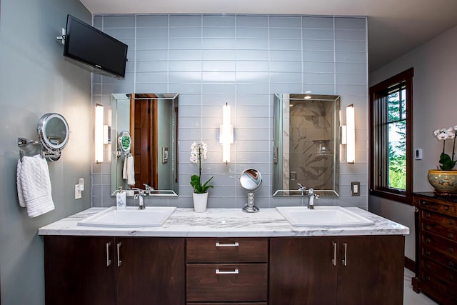 2475 E Lakeshore Dr, Whitefish, MT 59937 - bathroom with double vanity, a shower stall, backsplash, and tile walls