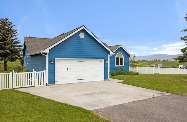 7580 Arroyo Ln, Missoula, MT 59808 - view of front facade featuring concrete driveway, an attached garage, a mountain view, and a shingled roof