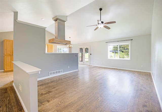 7580 Arroyo Ln, Missoula, MT 59808 - unfurnished living room with a ceiling fan, plenty of natural light, light wood-style flooring, and high vaulted ceiling