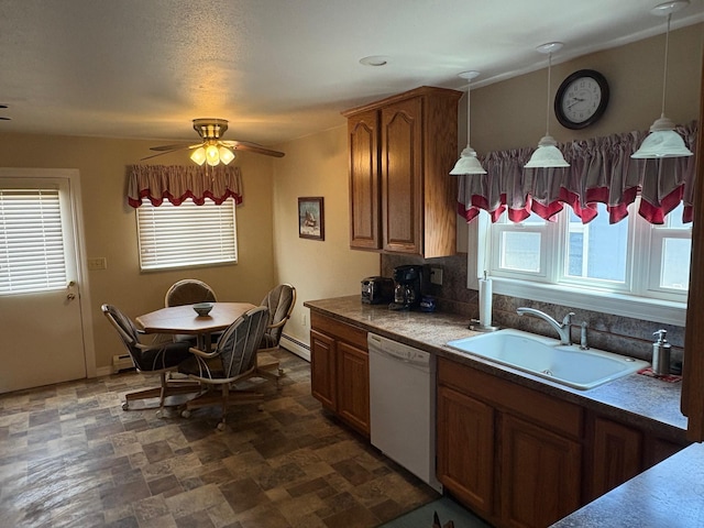 501 Elm St, Anaconda, MT 59711 - kitchen with dishwasher, a sink, stone finish flooring, and brown cabinets
