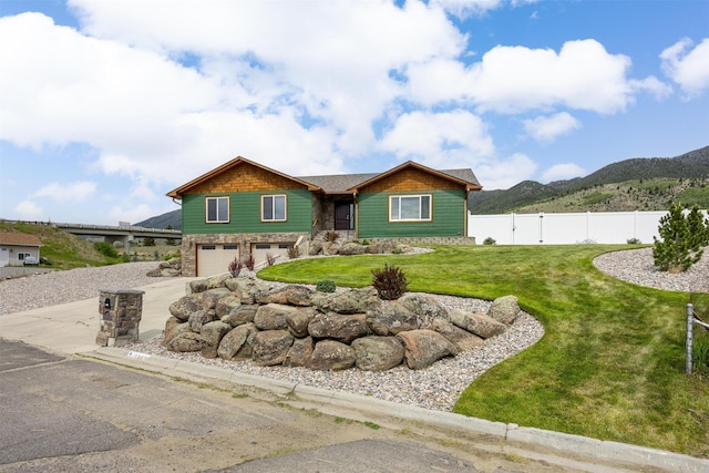116 Windameer Ct, Butte, MT 59701 - view of front facade with stone siding, a garage, concrete driveway, and a mountain view