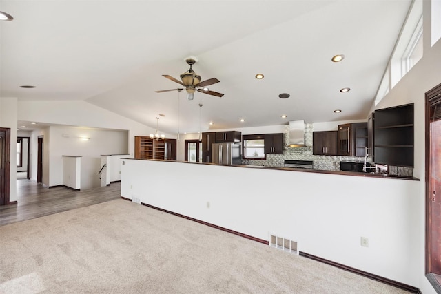 116 Windameer Ct, Butte, MT 59701 - unfurnished living room featuring vaulted ceiling, carpet flooring, ceiling fan, and recessed lighting