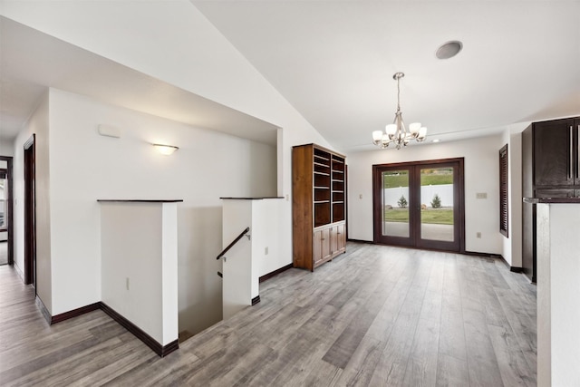 116 Windameer Ct, Butte, MT 59701 - unfurnished dining area featuring a chandelier, light wood-style floors, baseboards, and lofted ceiling