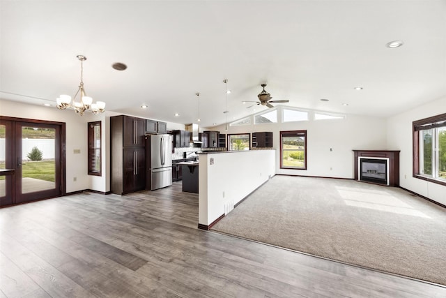 116 Windameer Ct, Butte, MT 59701 - kitchen with freestanding refrigerator, dark brown cabinets, open floor plan, a chandelier, and lofted ceiling