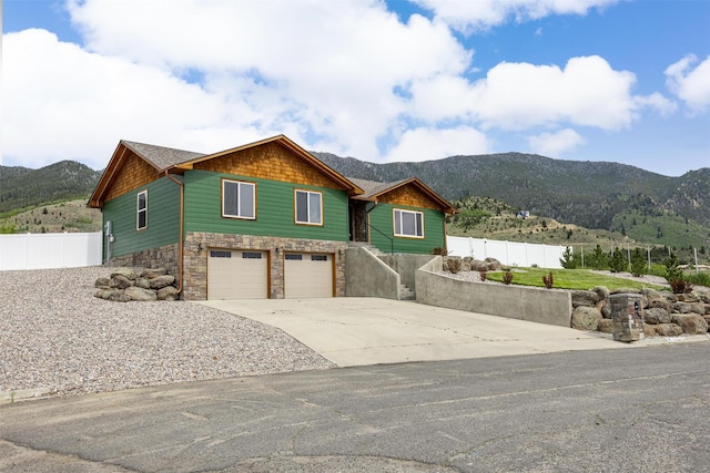 116 Windameer Ct, Butte, MT 59701 - view of front facade featuring a mountain view, a garage, driveway, and stone siding