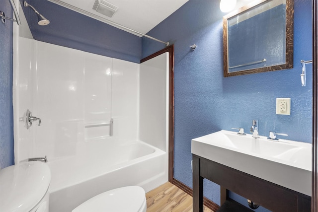 116 Windameer Ct, Butte, MT 59701 - full bath with toilet, a textured wall, wood finished floors, washtub / shower combination, and vanity