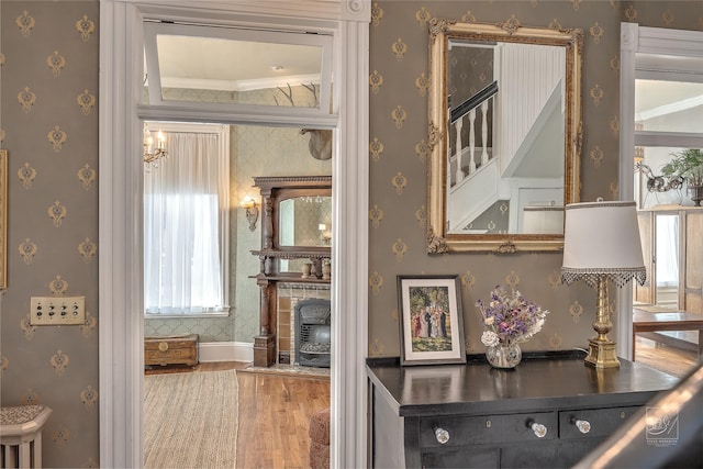 902 N Park Ave, Helena, MT 59601 - corridor with wallpapered walls, wood finished floors, and ornamental molding