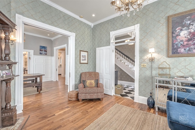 902 N Park Ave, Helena, MT 59601 - sitting room with wallpapered walls, ornamental molding, wood finished floors, stairway, and a chandelier