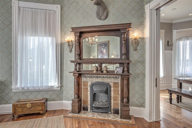 902 N Park Ave, Helena, MT 59601 - detailed view of wood finished floors, a tile fireplace, crown molding, and baseboards