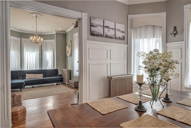 902 N Park Ave, Helena, MT 59601 - foyer with crown molding, wallpapered walls, a decorative wall, a chandelier, and hardwood / wood-style floors
