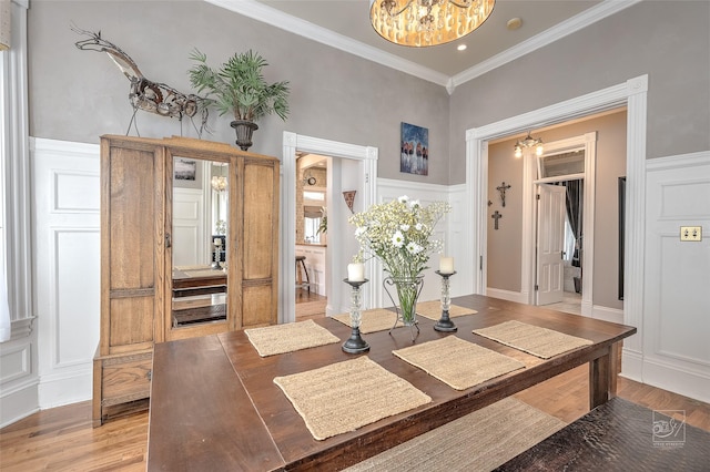 902 N Park Ave, Helena, MT 59601 - entryway featuring a chandelier, a decorative wall, crown molding, light wood finished floors, and wainscoting