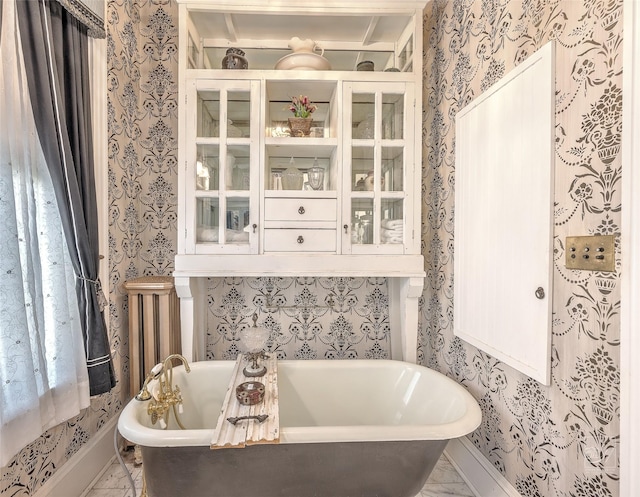 902 N Park Ave, Helena, MT 59601 - bathroom featuring wallpapered walls, a freestanding bath, and baseboards