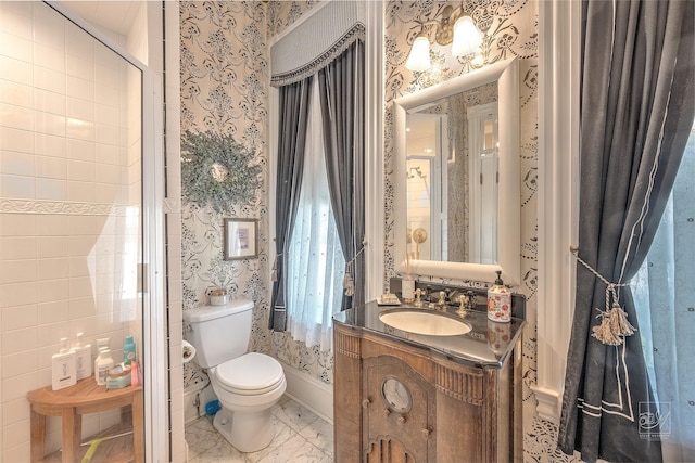 902 N Park Ave, Helena, MT 59601 - bathroom with wallpapered walls, vanity, toilet, and marble finish floors