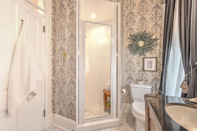902 N Park Ave, Helena, MT 59601 - bathroom with wallpapered walls, toilet, vanity, a stall shower, and marble look tiles