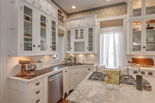 902 N Park Ave, Helena, MT 59601 - kitchen with stainless steel appliances, white cabinets, a sink, and decorative backsplash