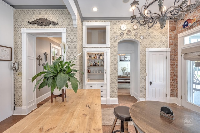 902 N Park Ave, Helena, MT 59601 - foyer featuring arched walkways, wallpapered walls, crown molding, healthy amount of natural light, and a chandelier