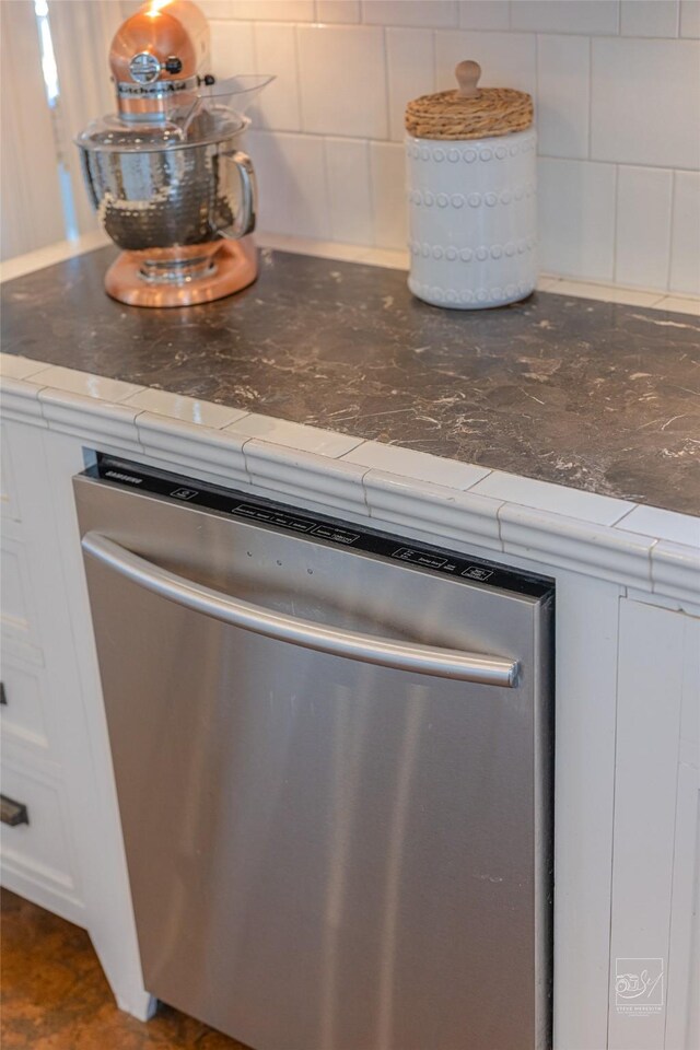 902 N Park Ave, Helena, MT 59601 - kitchen view of stainless steel dishwasher, tasteful backsplash, and white cabinets